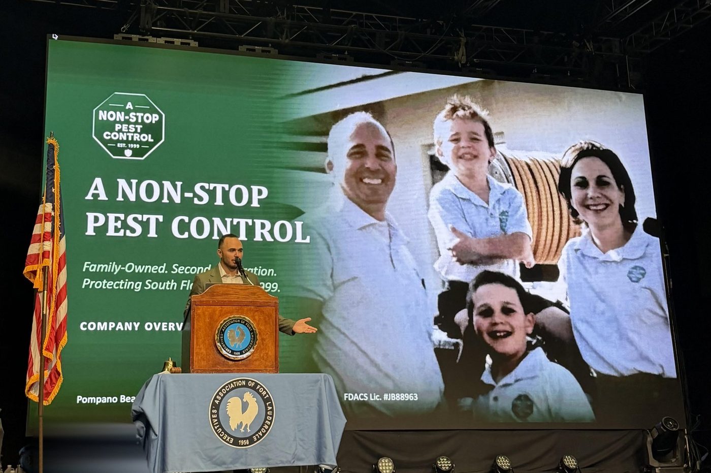 Presenting A Non-Stop Pest Control at the Executives' Association of Fort Lauderdale, with the 1999 family photo in company uniforms on screen